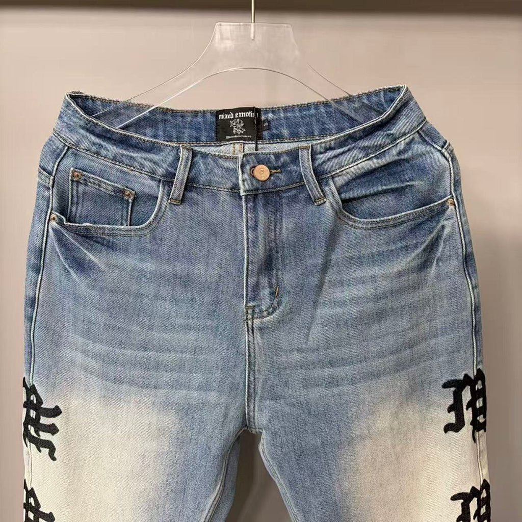 MIXED EMOTION Repeated Letter Side Graphic Jeans